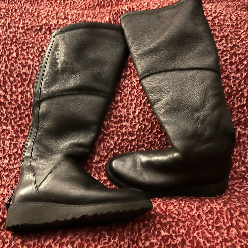Black knee high UGG boots with soft lining and zip back closure